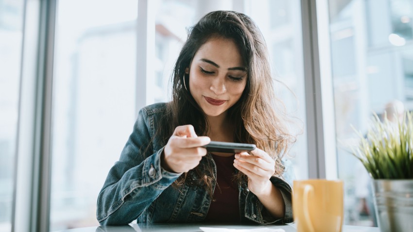 Woman depositing check on phone